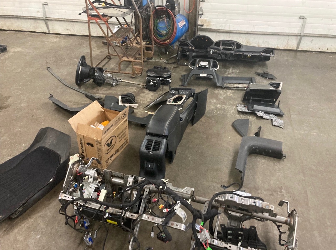 Interior parts removed and organized during vehicle repair